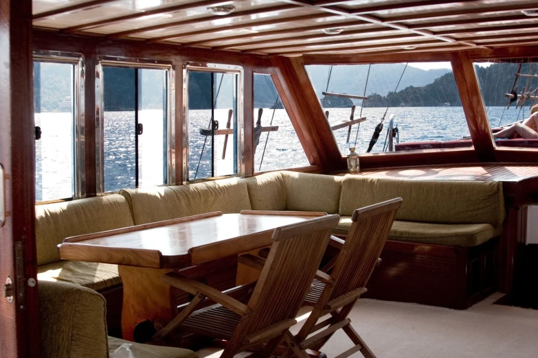 a person sits at a table while on a boat