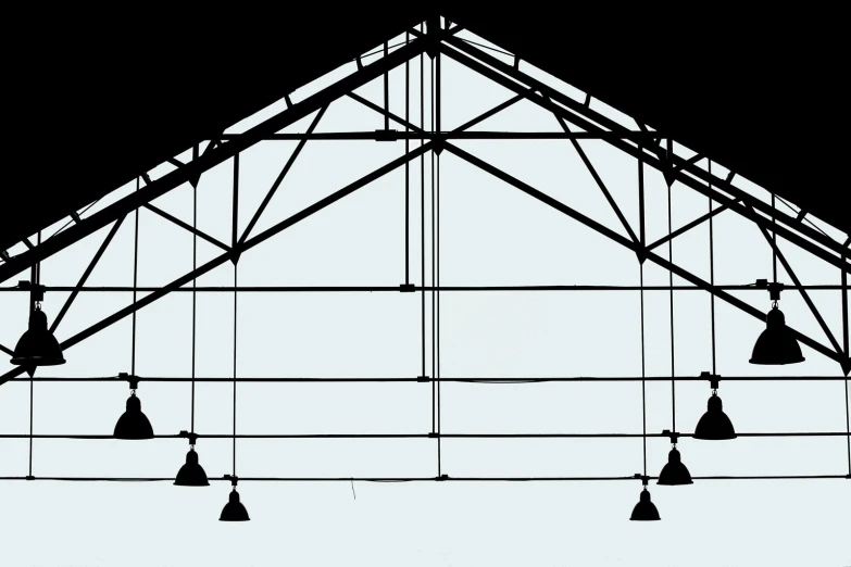 an image of hanging bells from the inside of a building