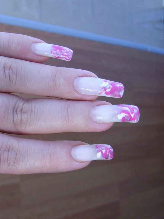 the nail polish has pink and white flowers on it