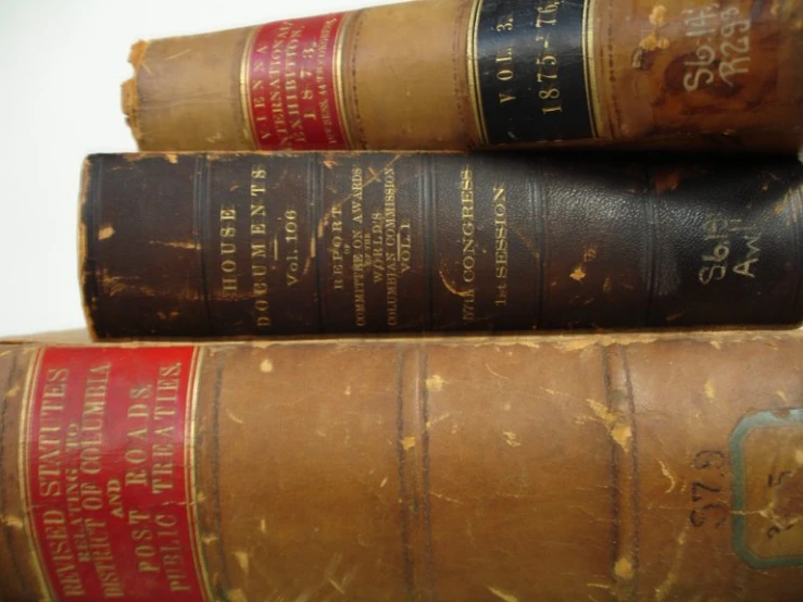 several old books stacked on top of each other