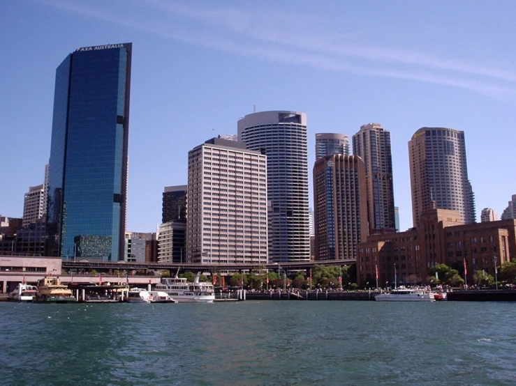 boats are moored near a large city