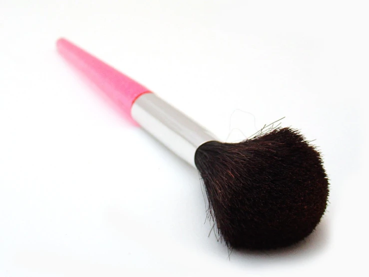 a closeup of a pink and white brush