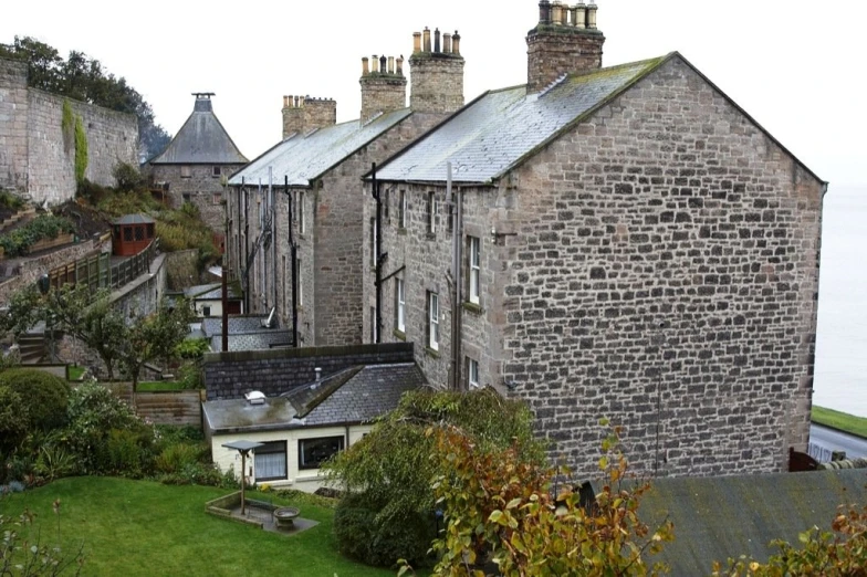 there are several old buildings near the water