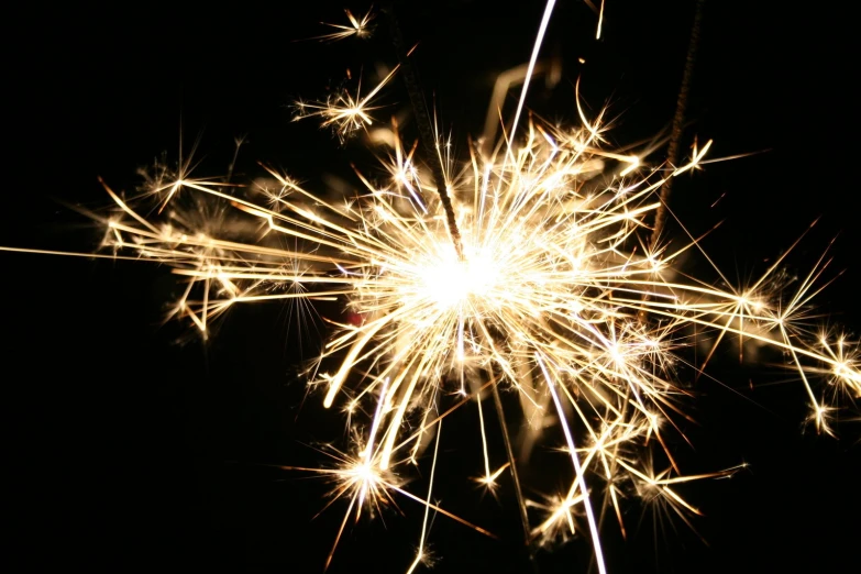 a fireworks with a black background and some bright orange