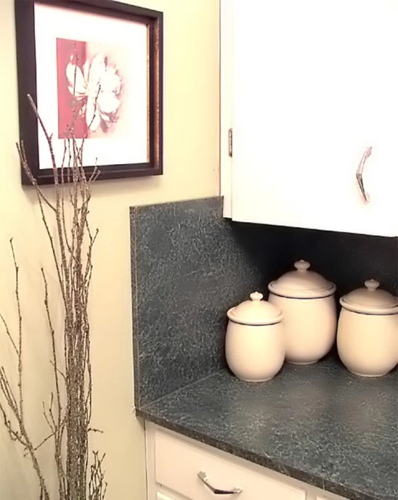 kitchen with white cabinets and black countertop and marble countertops