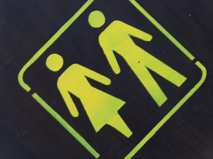 the neon yellow sign shows people walking through