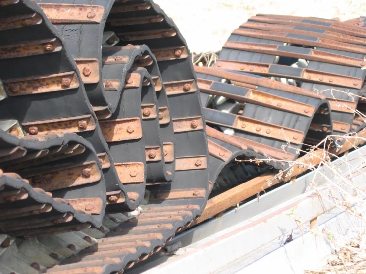 the tire of an old rusty machine sits in the dirt