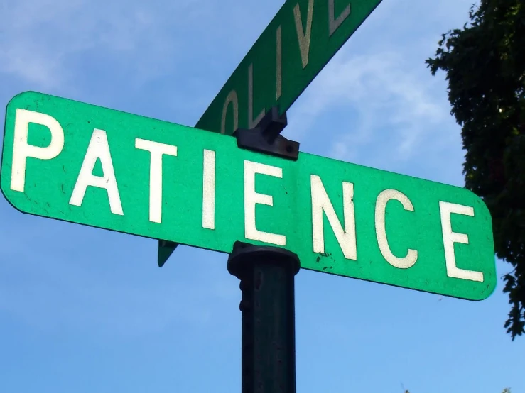 an intersection with two green street signs on it