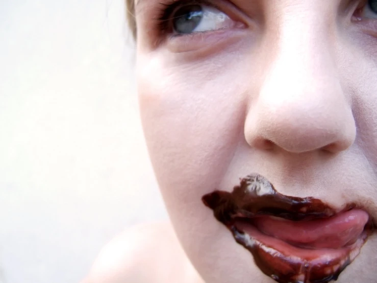 a woman with chocolate spread around her mouth