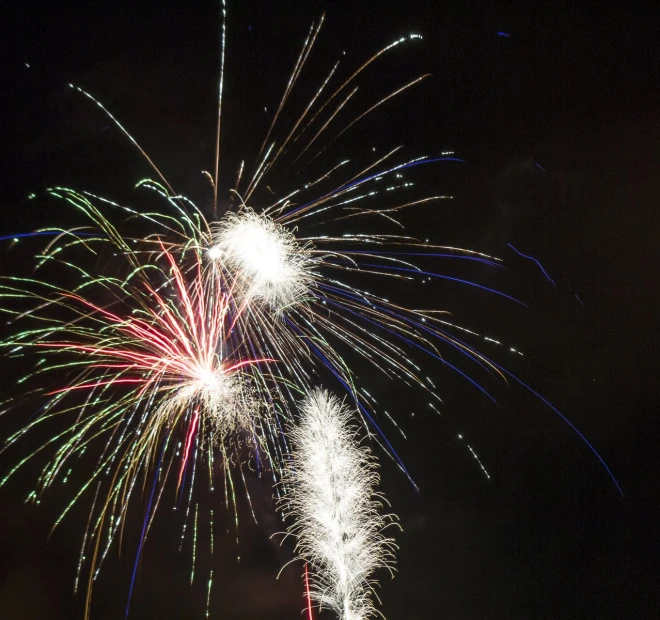 a fireworks display over a large field at night