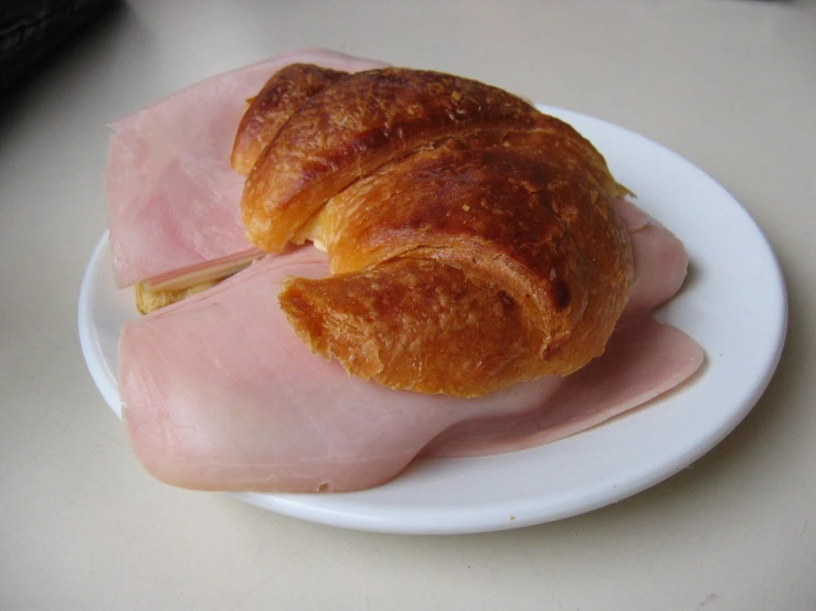 a white plate topped with pieces of ham