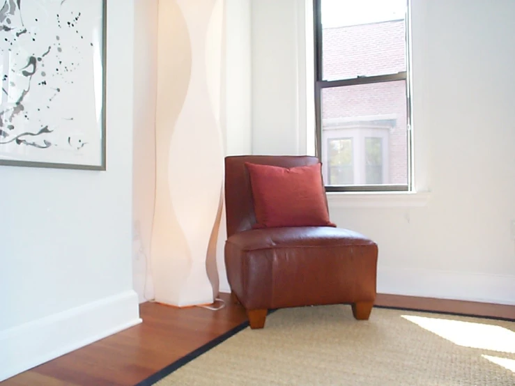 a leather chair sitting in front of a window