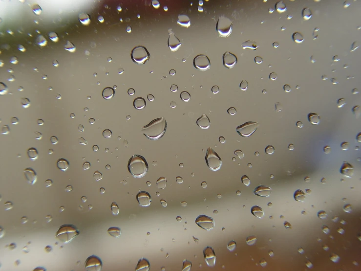 rain is being seen through the window on a rainy day
