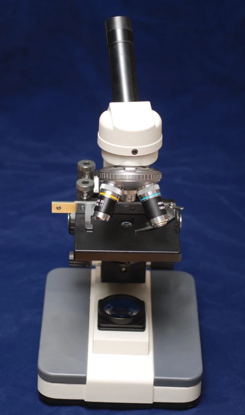 a microscope sitting on top of a counter with a camera in it