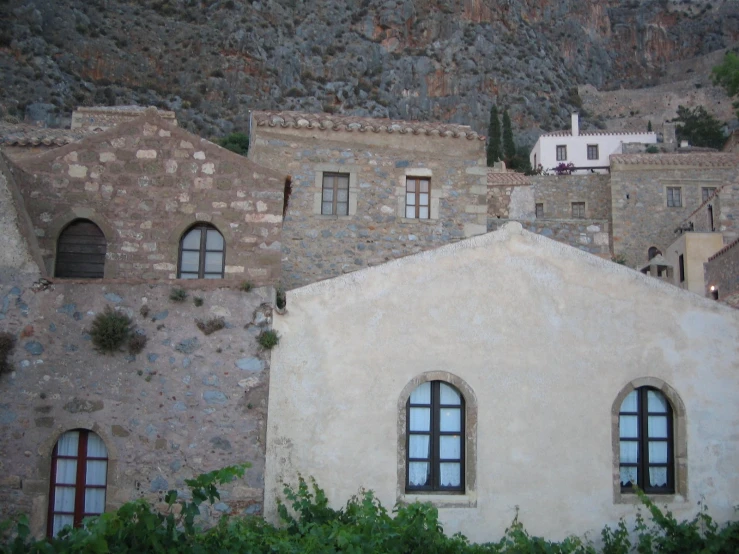 a building with three arched windows is in the foreground