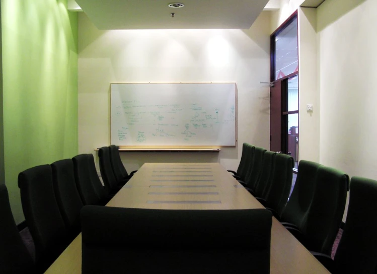 an empty conference room with green walls