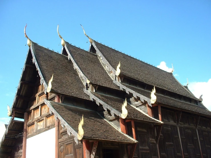 a building with a lot of windows and wood shingles