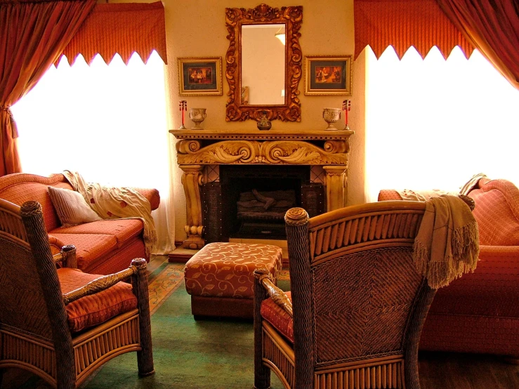 a living room with multiple couches and chair next to a fire place