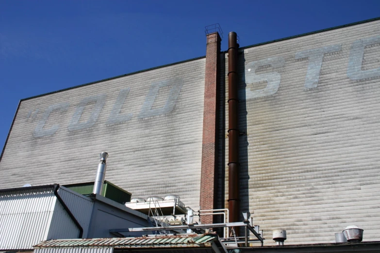 the side of a building, with an outside sign and a window