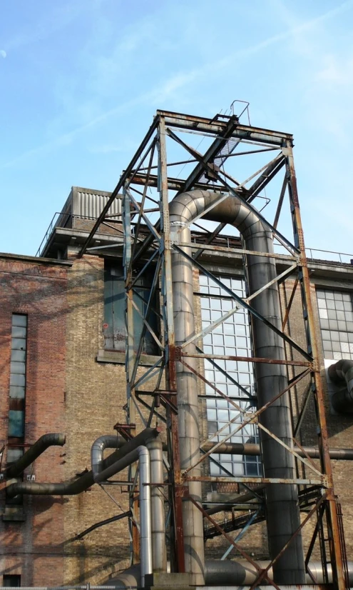 the corner of an industrial building with pipes