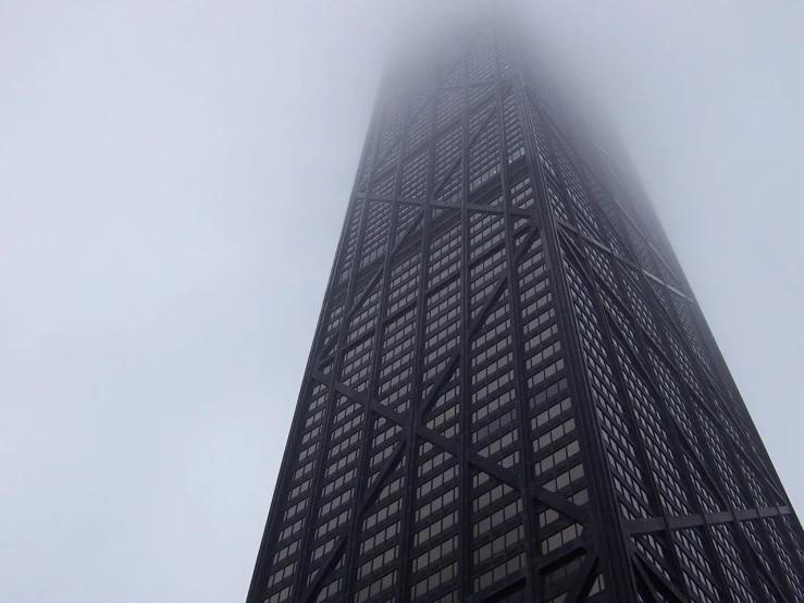 the top of a skyscr in a foggy sky