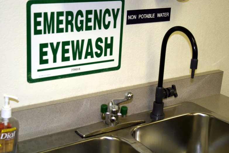 a hospital sign is on the wall behind a sink