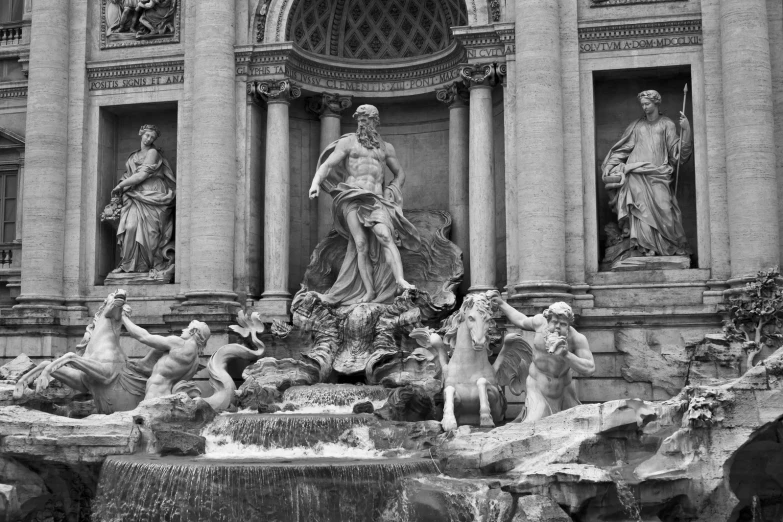 statues surrounding a fountain in front of a church