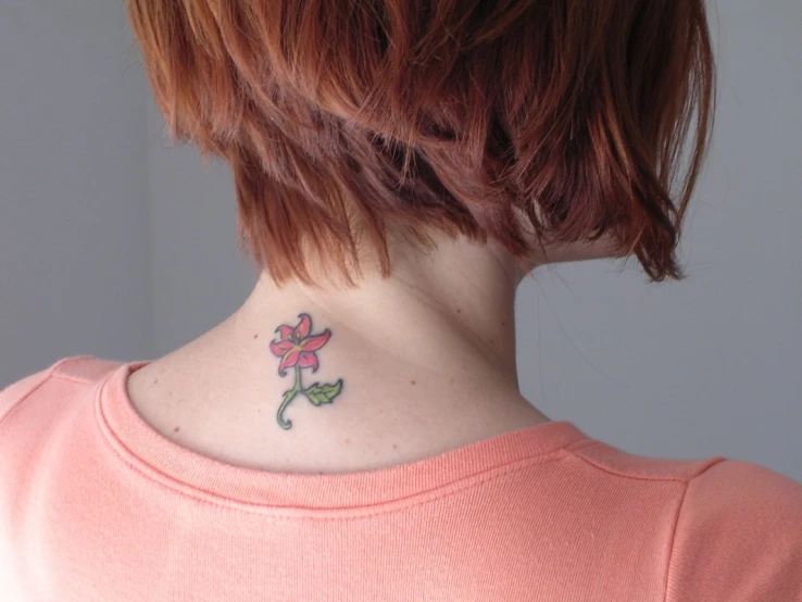 woman with tattoo flowers on her neck and neck