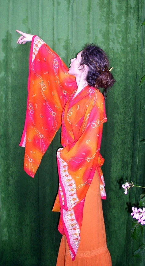 a young woman wearing a bright orange and red costume