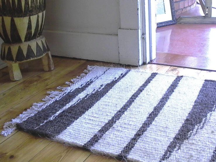 a striped rug on the floor next to a sliding glass door