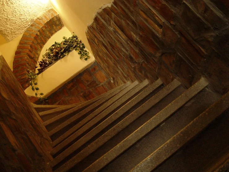 a brick wall and a staircase that goes up to the roof of a building