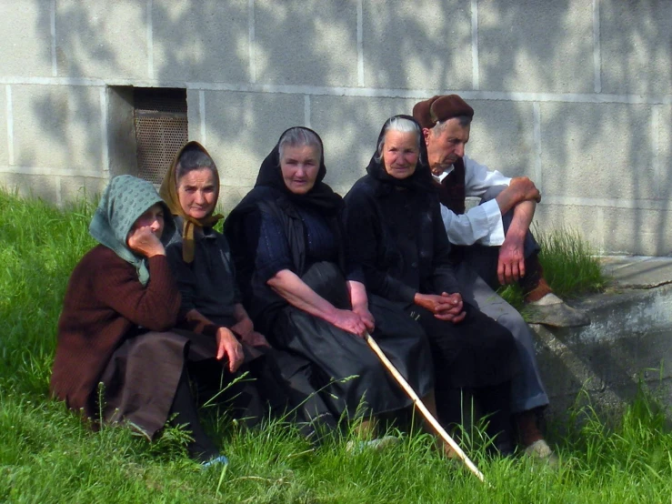 four old women sitting and posing for a po