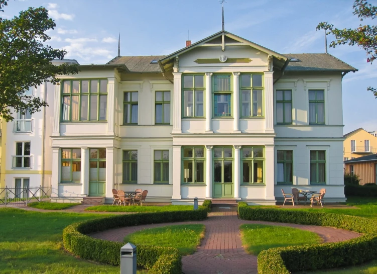 a white house with a garden in front