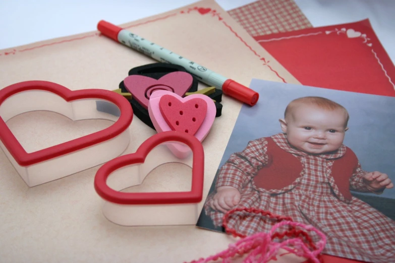 a cut out po with heart shape cutters next to a baby picture