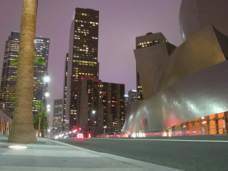 tall buildings with city lights at night in the background