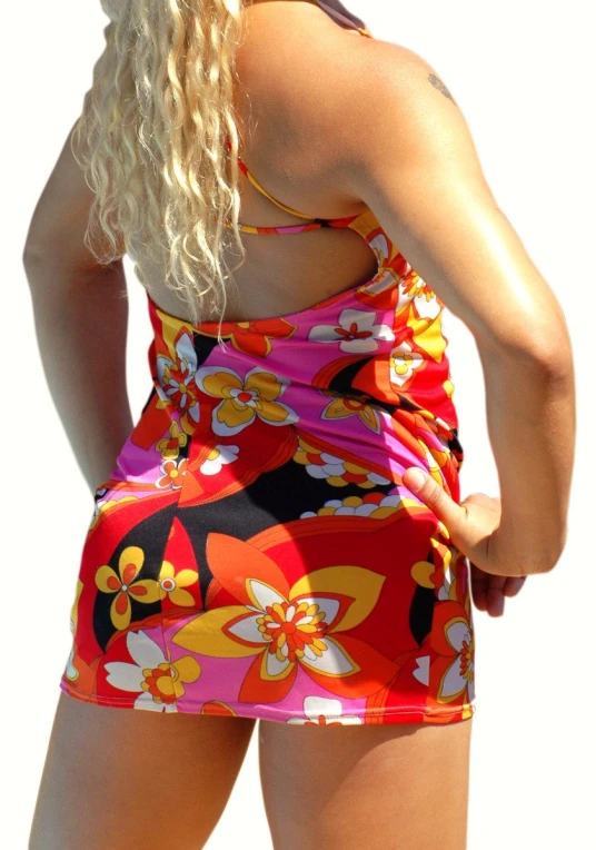 a girl in a colorful dress standing back to back