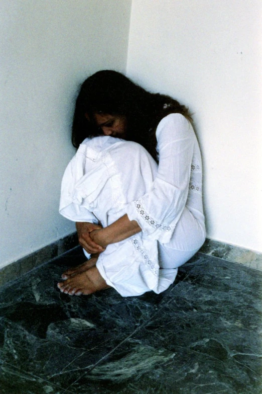 a woman that is sitting on the ground