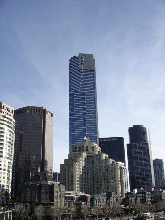 a group of skyscrs sitting next to each other in a city