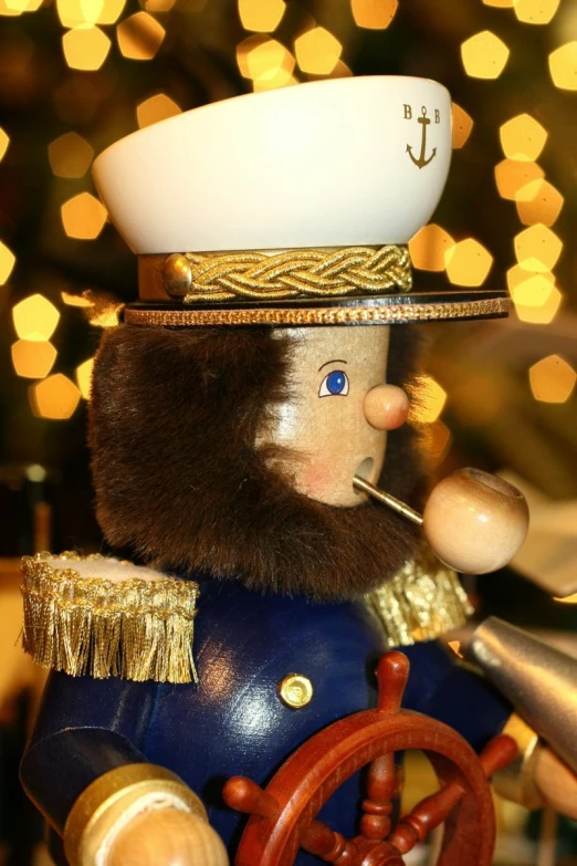 a toy sailor that is dressed in blue