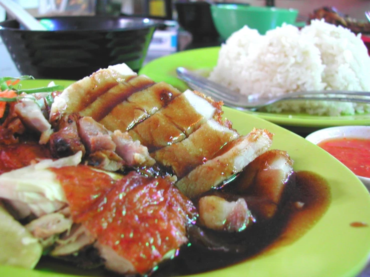 a green plate topped with food and meat