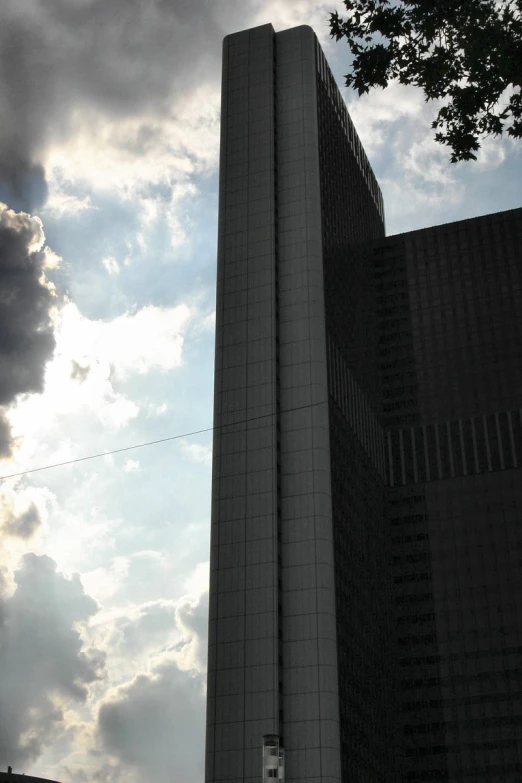 a tall building sitting under a cloudy sky