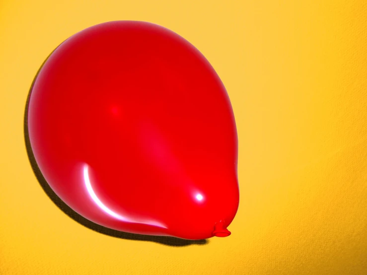 a red object with yellow background