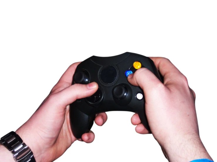 a close up of two hands holding a game controller