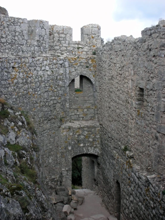 a very tall brick building with stone stairs and a tower