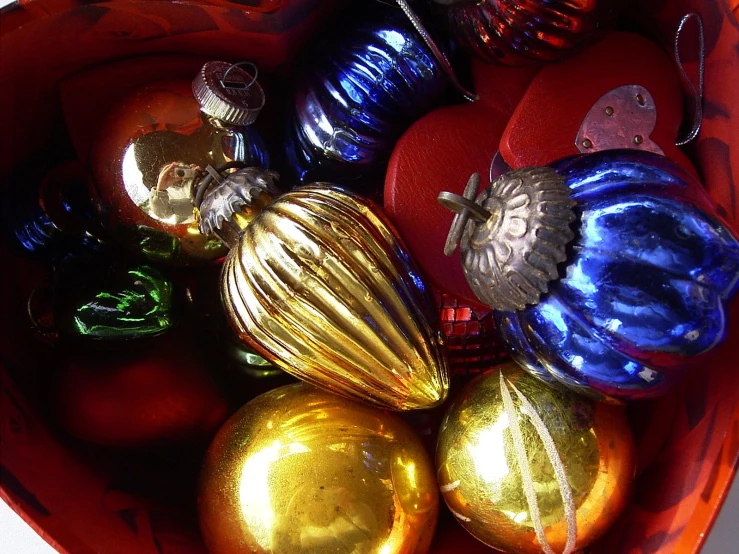 a bowl filled with ornaments and metallic ornaments