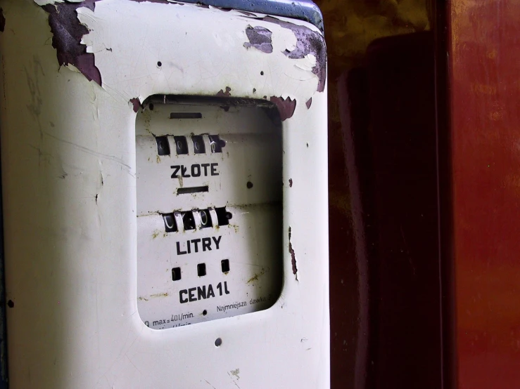 a dirty parking meter has the numbers to twenty and two, and two of the letters below are written