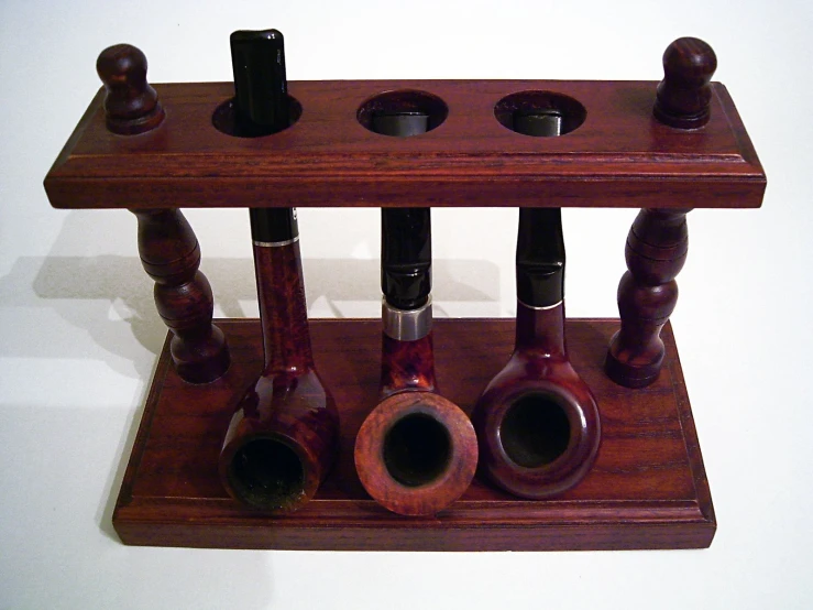 several wooden objects arranged in a holder on a wall