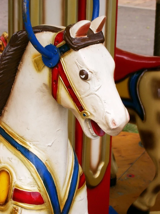 the horse statue has gold paint and red accents