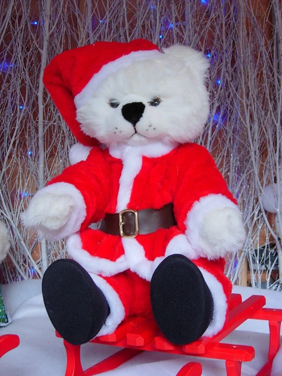 there is a teddy bear wearing santas outfit