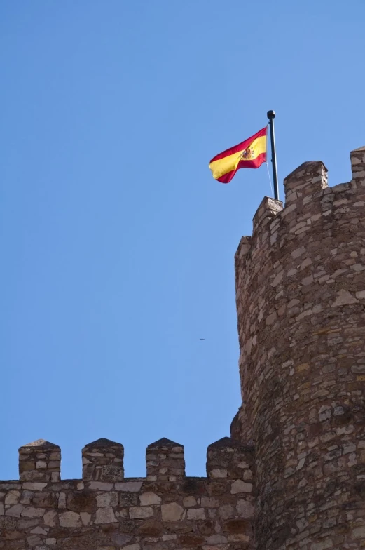 the flag of germany is flying on top of the castle